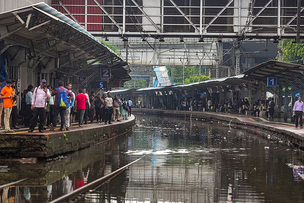 | Photo: PTI/Shashank Parade : Waterlogged railway station in Mumbai